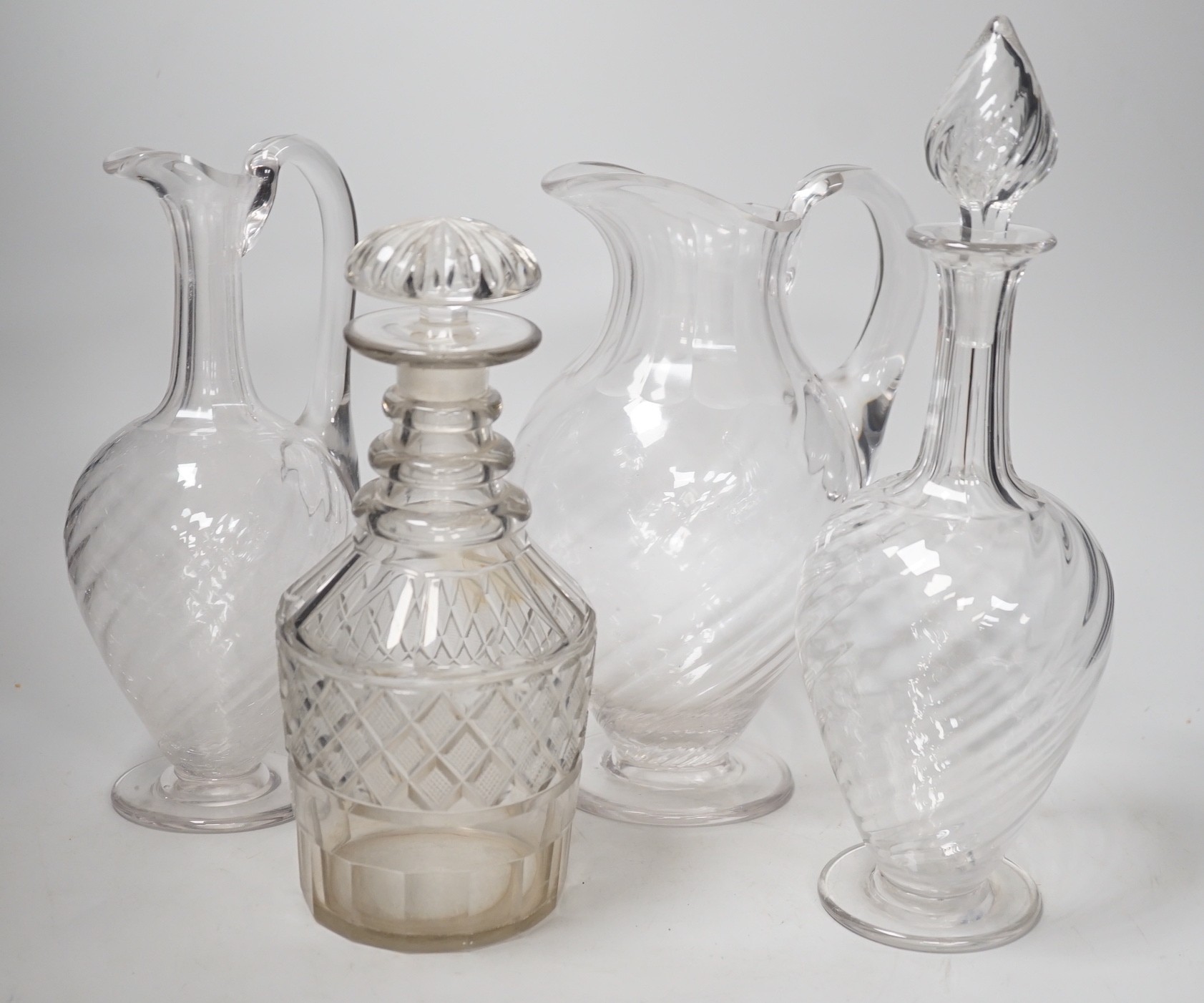 Two Victorian cut glass decanters, a ewer and a jug. Tallest 32cm